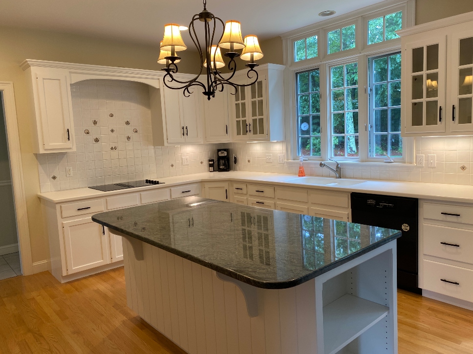 Professional white spray paint finish on kitchen cabinets