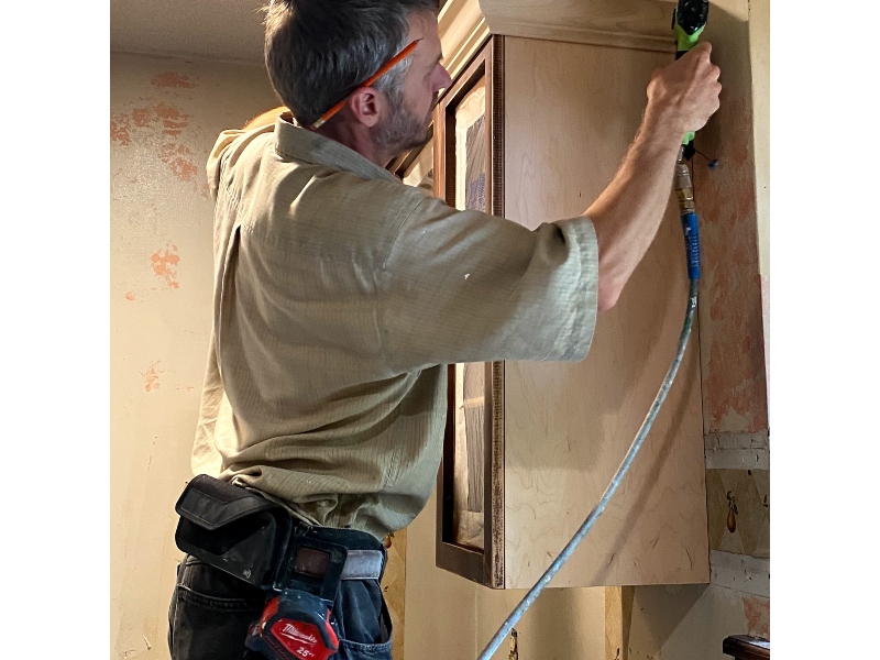 Decorative crown molding added to upper kitchen cabinets