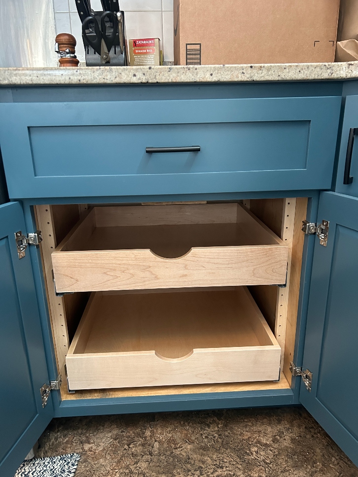 Adjustable pull-out drawer shelves — custom-fit rollout shelves installed in base cabinets replacing fixed shelves