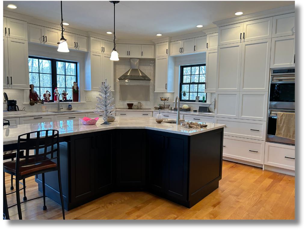 Two-tone kitchen — white upper cabinets, black lower cabinets with pendant lighting