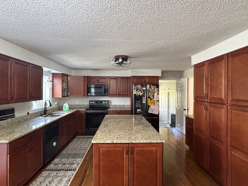 Cherry wood kitchen cabinets before professional painting