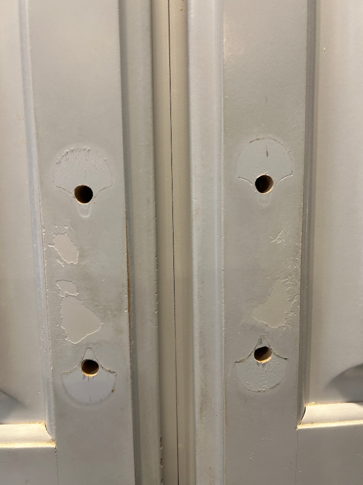 Deteriorating cabinet finish around handles — worn kitchen cabinet doors needing professional refinishing