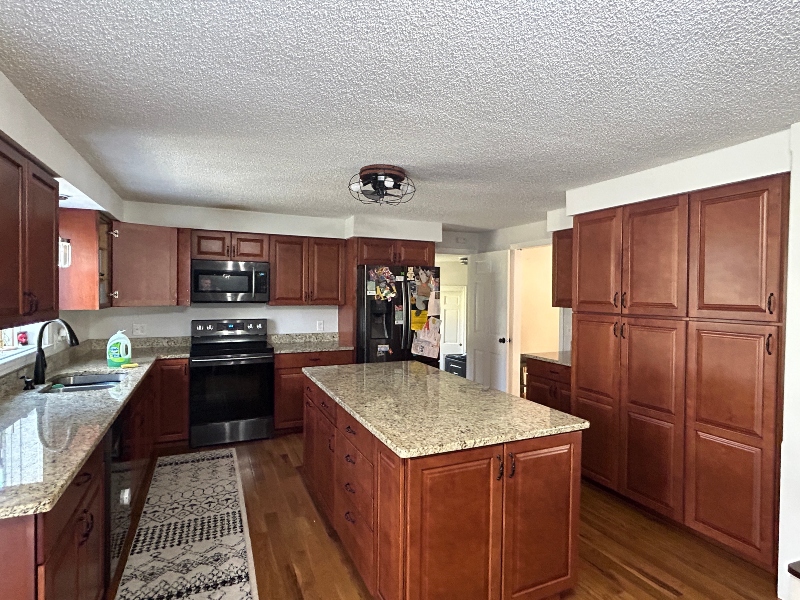 Custom mudroom bench with cubbies and overhead cabinets — Massachusetts
