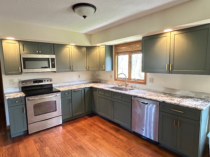 Honey oak cabinets refaced to green shaker in Chicopee, MA