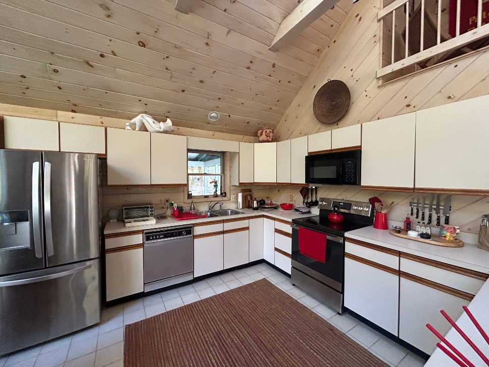 Old melamine cabinets before cabinet refacing project in Becket MA