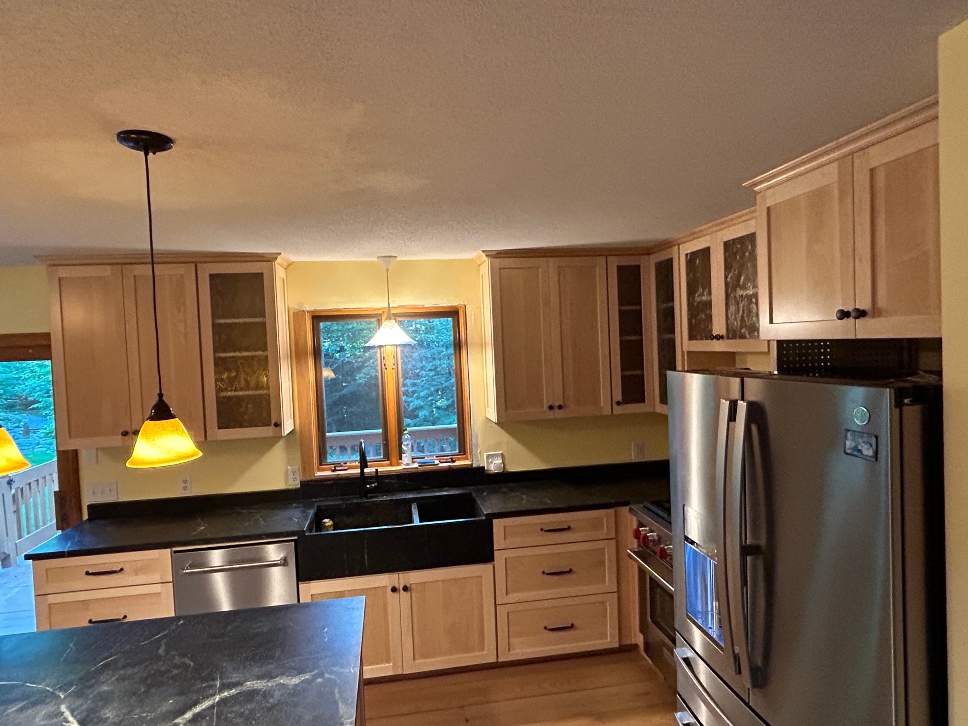 Natural maple veneer refacing applied over existing oak cabinets