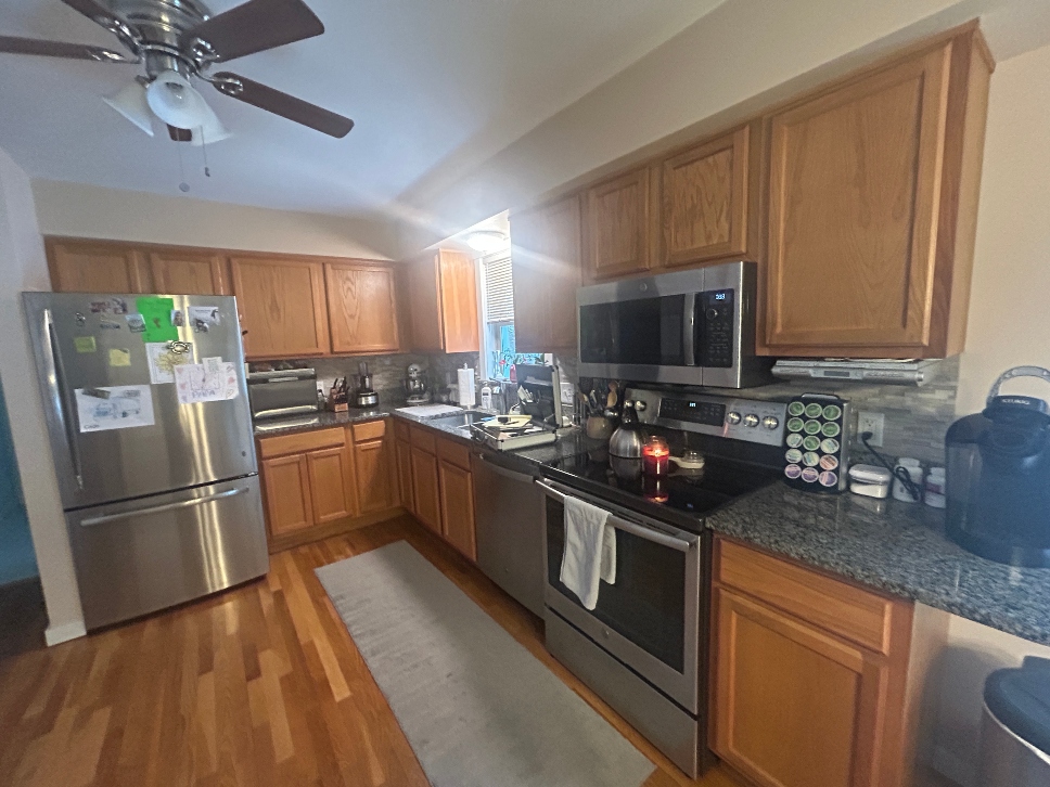 Honey oak kitchen cabinets before refacing in Stafford, CT