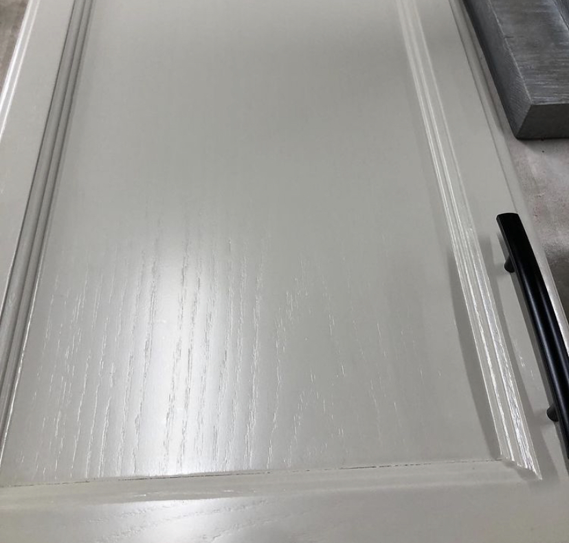 Oak cabinet door painted showing grain texture — grain still visible after standard painting process