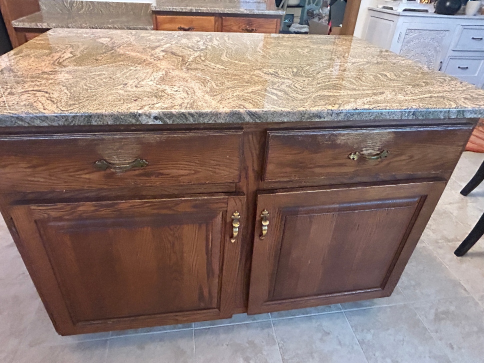 Cabinet finish showing water damage before refinishing