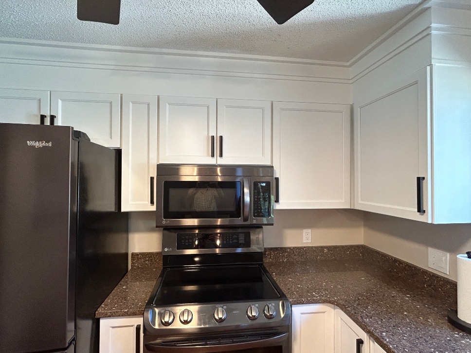 Cabinets extended to the ceiling — upper kitchen cabinets raised to ceiling height eliminating soffit gap